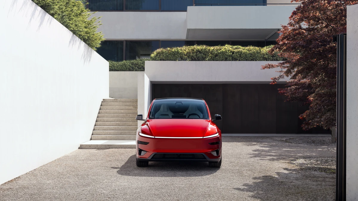Tesla Model Y estacionado en la entrada de una vivienda moderna