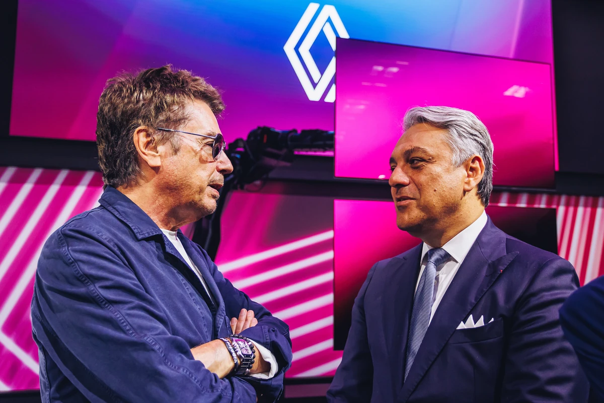 Jean-Michel Jarre conversing with Luca de Meo at a Renault presentation, discussing the sound identity of electric vehicles.